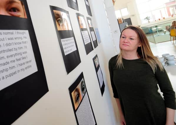 Young persons outreach worker Carwen Jones, of Basis Yorkshire, looks over the In Our Own Words exhibition. Pictures: Simon Hulme