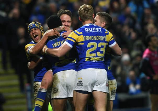 Leeds Rhinos players celebrate with Kallum Watkins after he scored his second try against Hull FC.