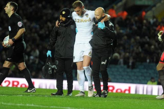Leeds United captain Liam Cooper limps out of Wednesday's defeat to Wolves.