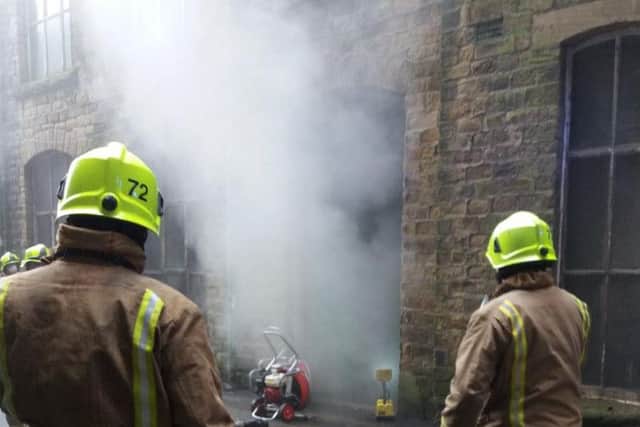 Firefighters at the scene in Huddersfield. Picture: West Yorkshire Police Roads Policing Unit.