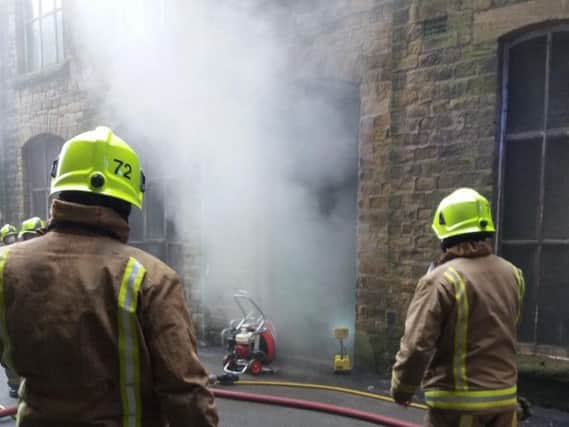Firefighters at the scene in Huddersfield. Picture: West Yorkshire Police Roads Policing Unit.