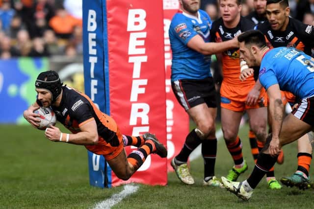 Luke Gale dives over the Salford try line for the Tigers. PIC: Jonathan Gawthorpe