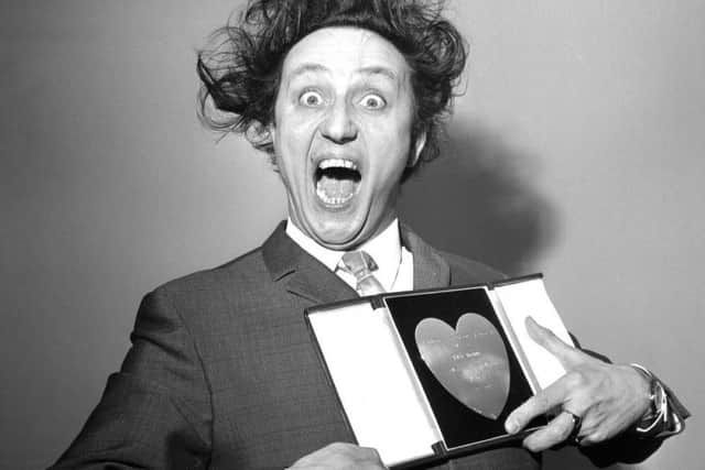 Sir Ken Dodd, who has died aged 90, with his award for Show Business Personality of the Year, presented to him at the Variety Club's luncheon in 1966.