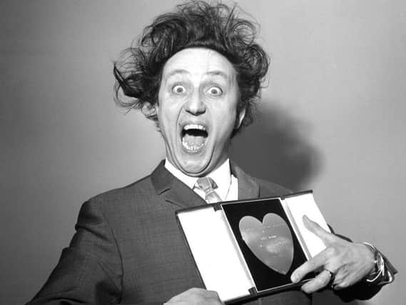 Sir Ken Dodd, who has died aged 90, with his award for Show Business Personality of the Year, presented to him at the Variety Club's luncheon in 1966.