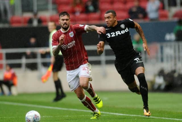 Jay-Roy Grot takes on Marlon Pack during Leeds' 3-0 victory at Bristol City.