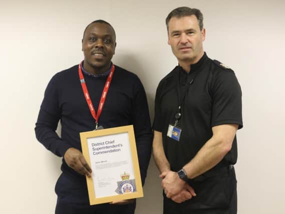 Jason Minott receives his commendation from Chief Superintendent Paul Money.