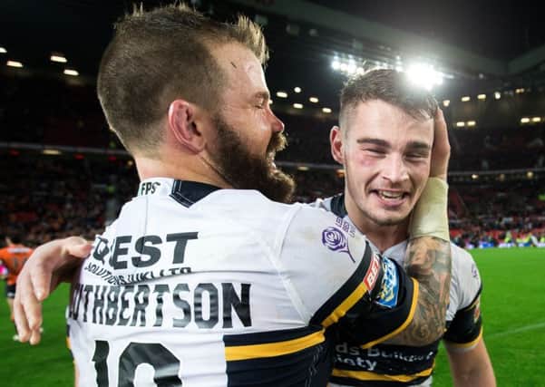 Adam Cuthbertson celebrates with Stevie Ward after the Grand Final last year.