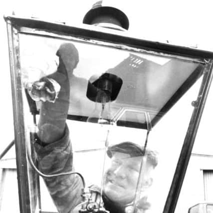 Leeds, Sweet street, 28th March 1979
LIGHTING
Mr. Eddie Mullan, a lift engineer at the City of Leeds Public Works Department, Sweet Street, gives a last polish to one of the four old gas lamps that are to be sent to Germany.