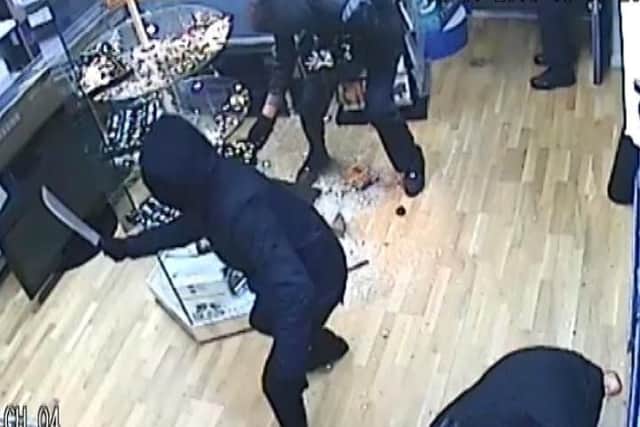 CCTV images show the gang attacking the shop with machetes.