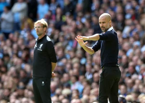 WE'LL MEET AGAIN: Manchester City manager Pep Guardiola (right) and Liverpool manager Jurgen Klopp. Picture: Martin Rickett/PA