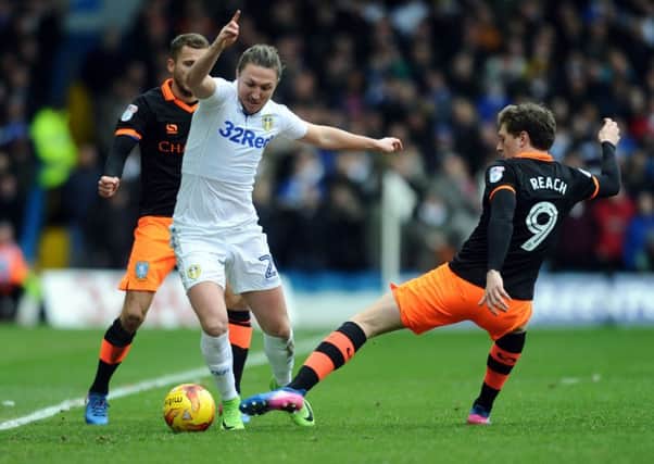 HELLO AGAIN: Leeds United's Luke Ayling takes on Sheffield Wednesday's Adam Reach. Picture: Jonathan Gawthorpe