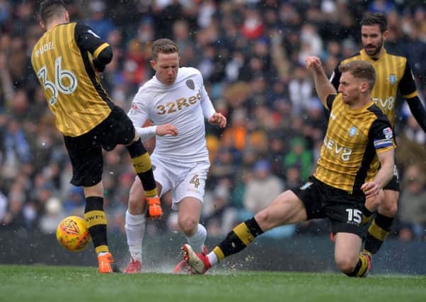 Adam Forshaw is challenged by Daniel Pudil and Tom Lees.