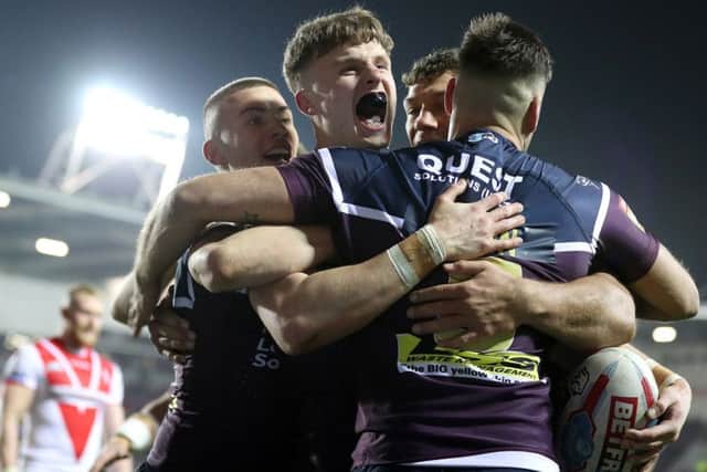 Ash Handley (second left) celebrates scoring his second try against St Helens. PIC: Martin Rickett/PA Wire