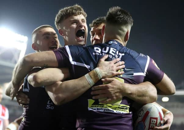 Ash Handley (second left) celebrates scoring his second try against St Helens.