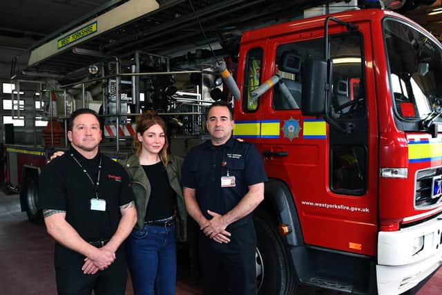 Lou Evans, who was rescued from the River Aire and reunited with the fire crews from Leeds Fire Station, who saved her life. She is pictured with Richard Goc, who raised the alarm and firefighter Andrew Sharp, who went in the river to save her.