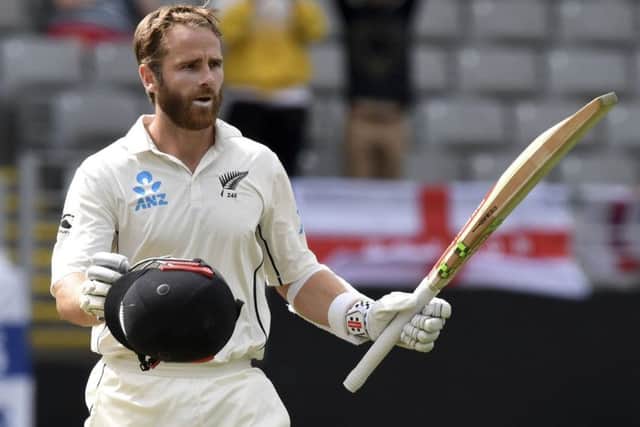 New Zealand's Kane Williamson signals his century against England during their first cricket test in Auckland. (AP Photo/Ross Setford)