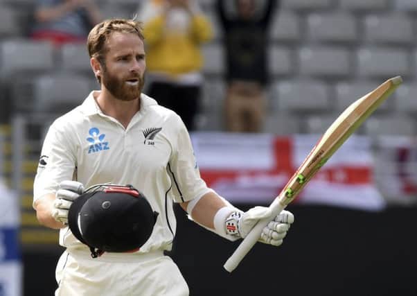 New Zealand's Kane Williamson signals his century against England during their first cricket test in Auckland. (AP Photo/Ross Setford)