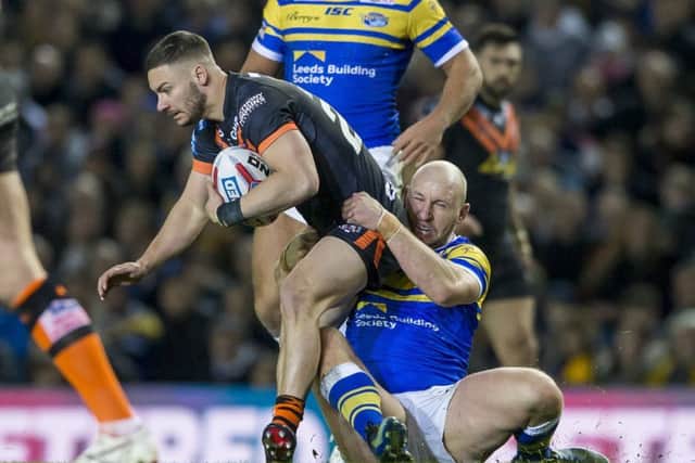 Castleford's Jy Hitchcox is tackled by Leeds' Carl Ablett.