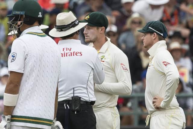 THERE MAY BE TROUBLE AHEAD: Australias Cameron Bancroft talks to the umpire on the third day of the Test match between South Africa and Australia at Newlands, with his captain Steve Smith, right, looking on. Picture: AP.