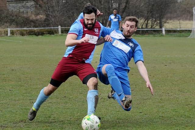Tom McMullen, of Rawdon OB, holds off Stephen Richardson, of Division One rivals Whitkirk Wanderers. PIC: Steve Riding