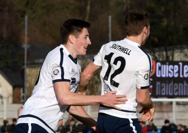 Guiseley's on-loan Forest defender Adam Crookes, left, celebrates with team-mate Dayle Southwell. PIC: James Hardisty