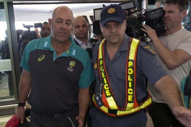 Australian cricket coach Darren Lehmann arrives with his team at the Cape Town International airport ahead of flying to Johannesburg for the final Test against South Africa (Picture: Halden Krog/AP).