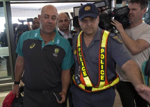 Australian cricket coach Darren Lehmann arrives with his team at the Cape Town International airport ahead of flying to Johannesburg for the final Test against South Africa (Picture: Halden Krog/AP).