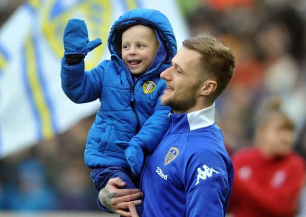 Young Leeds United fan Toby Nye with Whites captain Liam Cooper.