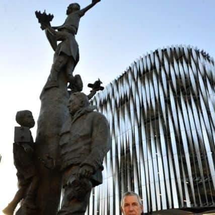Dr Stewart Manning  next to  the Arthur Aaron VC  statue on the roundabout at the bottom of Eastgate in Leeds .  PICS: Gary Longbottom/YPN
