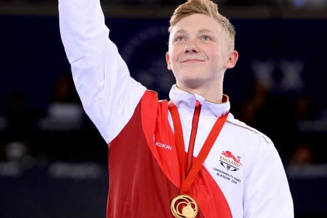 England's Nile Wilson with his gold medal won in the Men's Horizontal Bar Final, at the SSE Hydro, during the 2014 Commonwealth Games in Glasgow.