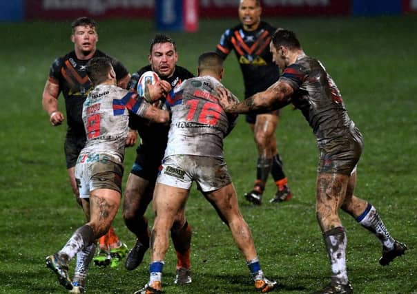 Castleford's Grant Millington is tackled by Wakefield's Kyle Wood and Tinirau Arona. (Picture: Jonathan Gawthorpe)