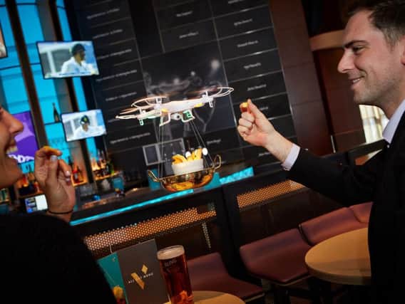 The drones will deliver food to customers at their tables.