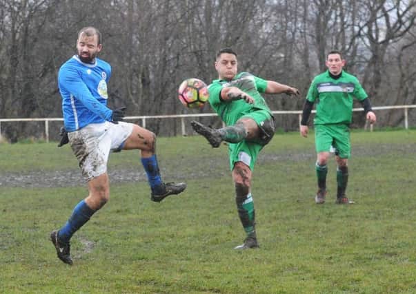 Calverley's Steve Wells takes evasive action from a volley from Matty Boyes, of Beeston St Anthony's, in the Yorkshire Amateur League. PIC: Steve Riding