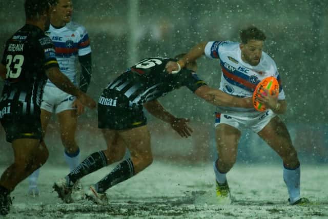 Danny Kirmond battles blizzard conditions as well as the Widnes defence. PIC: Stephen Gaunt/Touchlinepics.com