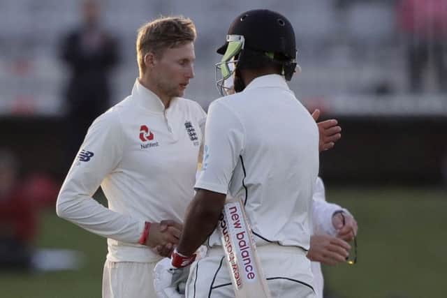 England's Joe Root, left, shakes the hand of New Zealand's Ish Sodhi at the conclusion of play on the final day at Hagley Oval. Picture: AP/Mark Baker.