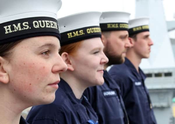 MAKING WAVES: Members of the ships company assemble on the bridge wing  of Britains new supercarrier HMS Queen Elizabeth.