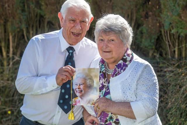 DIAMOND COUPLE: Mr and Mrs Swift with their card from the Queen.