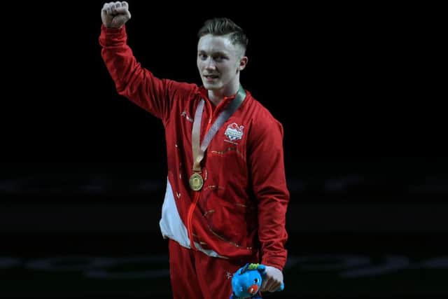 England's Nile Wilson celebrates winning a gold medal in the Men's Individual All-Round Final with coach Ben Collie at the Coomera Indoor Sports Centre during day three of the 2018 Commonwealth Games in the Gold Coast, Australia.  (Pictures: Mike Egerton/PA Wire)