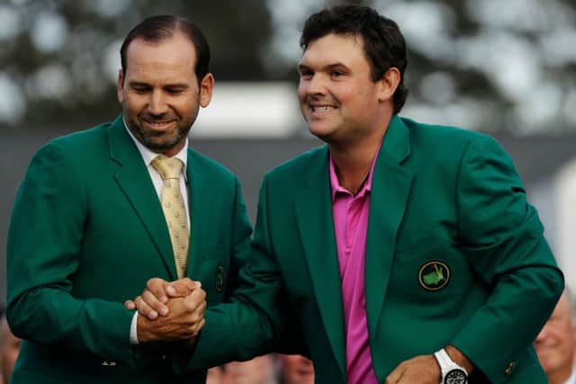Winner: Former Masters champion Sergio Garcia, left, shakes hands with Patrick Reed after his victory at the Masters.
