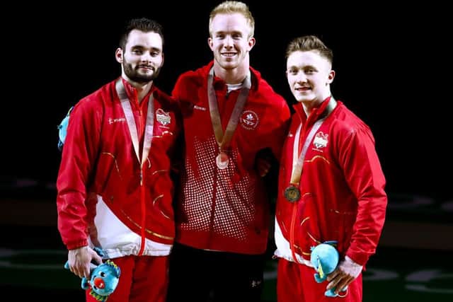 England's Nile Wilson (right) with his gold medal, Canada's Cory Paterson with his silver medal (centre) and England's James Hall with his bronze medal won in the Men's Horizontal Bar at the Commonwealth Games.
