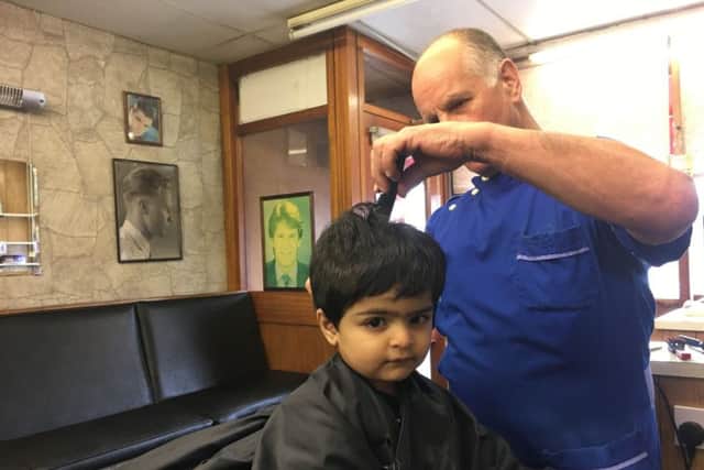 Bruno's men's hair salon in Harehills is closing after 54 years. John Kay cuts Hartman Gill's hair.