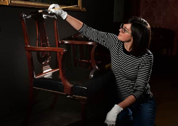 CLEAN-UP: Ruth Martin, Leeds City Museums curator of special exhibitions, cleans  a 1768 chair made for Robert Adams classical library at Nostell Priory.