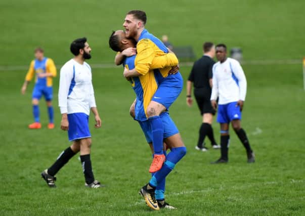 Hope Inn's Stephen Crawford is congratulated scoring his side's second goal by Daniel Maw.