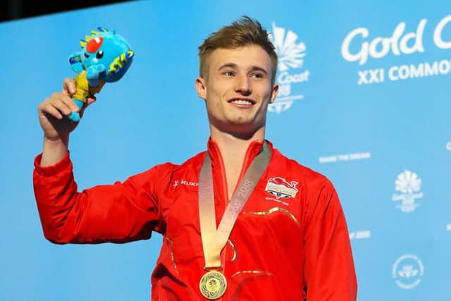 Jack Laugher receives his gold medal after the Men's 1m Springboard Final.