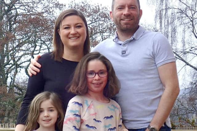 STRONGER: Ivy Cook, second from right, with her parents James and Emma and younger sister Olive.