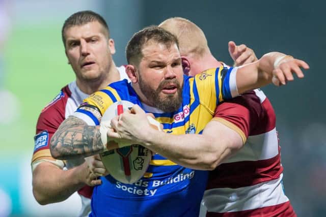 Adam Cuthbertson is tackled by Wigan's Tony Clubb and Liam Farrell.