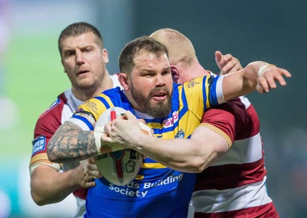 Adam Cuthbertson is tackled by Wigan's Tony Clubb and Liam Farrell.