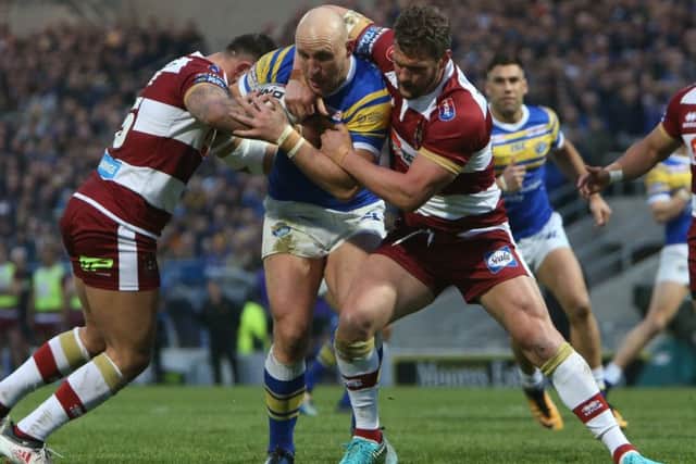 Carl Ablett is tackled by the Wigan defence.