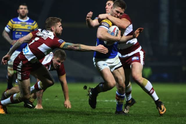 Matt Parcell is halted by the Wigan defence.