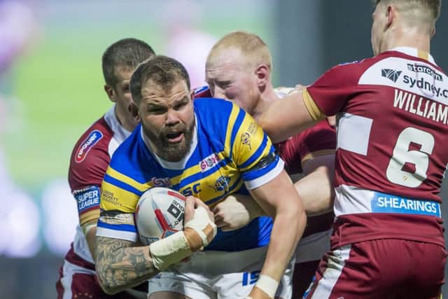 Adam Cuthbertson is tackled by Wigan's Tony Clubb, Liam Farrell and George Williams.